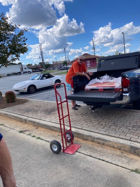 Randy taking a break after unloading a pallet of water