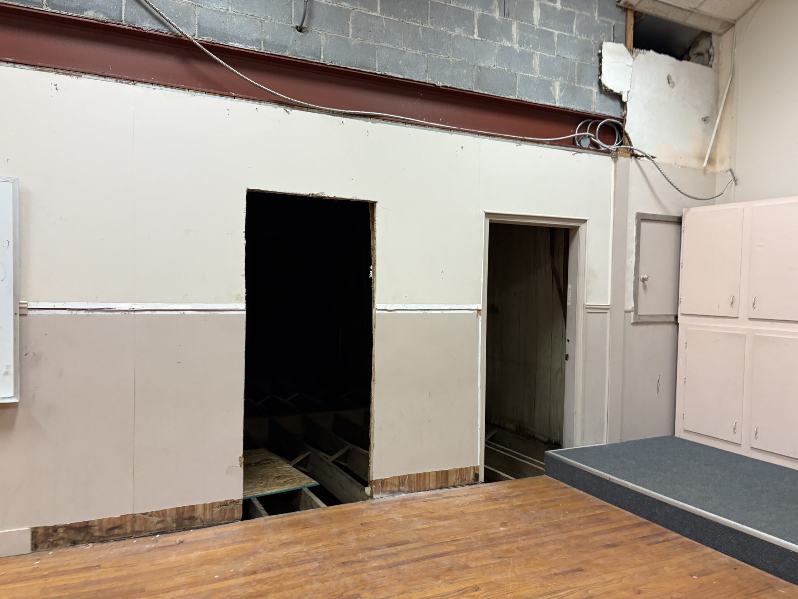 new handicap door opening, old door partly block byraised stage